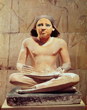 Scribe seated cross-legged holding a papyrus scroll, from Saqqara, Old Kingdom c.2475 BC (limestone)