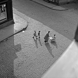 A woman with two children and a pram crossing a street at Bad Homburg, Germany 1930s (b/w photo)