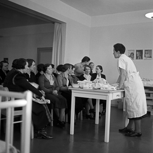 Women learn how to change the baby's nappy at a mother training of the Reichsmuetterdienst at Essen, Germany 1930s (b/w photo)