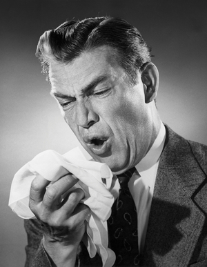 Mature man sneezing