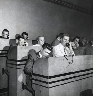 Group of businessmen talking on the phone in a stock market