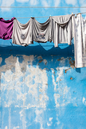 Facades of houses with laundry to dry,

 Burano, 2023 (photo)