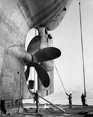 Three dock workers cleaning an industrial ship on a dry dock, Todd Shipyards Corporation, Hoboken, New Jersey, USA