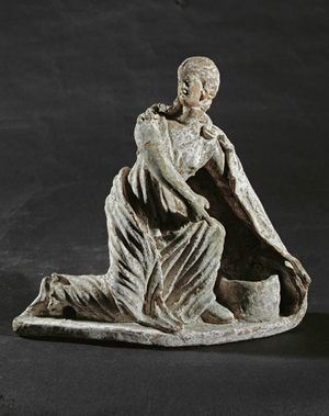 Woman in draped robe kneeling before a basket …