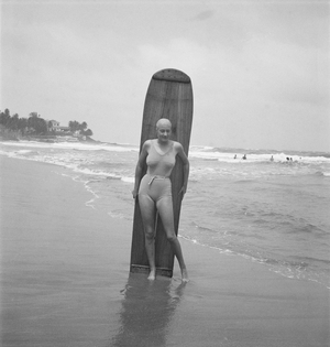 Surf rider and board, Ceylon, 1935 (b/w photo)