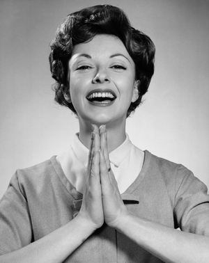 Studio portrait of young woman praying
