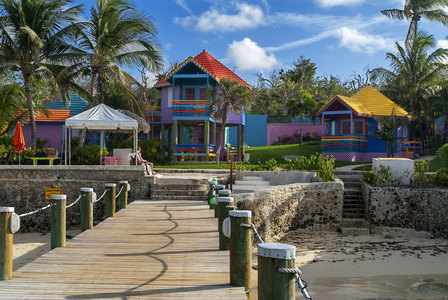Wooden pier at Hotel Compass Point Resort at Love beach Nassau, Bahamas, Caribbean. Brightly Colored Cottages At Compass Point Beach Club, 2019 (photo)