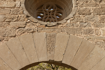 Castle (Castell de Montmagastre). The church. South entrance portal. Detail with the rose window.