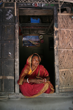 Family members of a Palanquin porters group passing their idle time. Palanquins are still used for carrying brides in remote Bangladesh. In Mathbari, a far-off village in Sundarbans, some people still cling to palanquins. The palanquin-porters are saving a heritage, a century old culture of the soil, for the sake of saving their lives in a miserable way. Mathbari, Kaira, Bangladesh. May 05, 2007.  (photo)