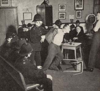 Policemen training how to handle a troublesome man in a pub (b/w photo)