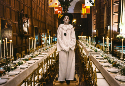Actor in costume of Pierrot in the Folger Shakespeare Library waits to greet donors, 1986 (photo)