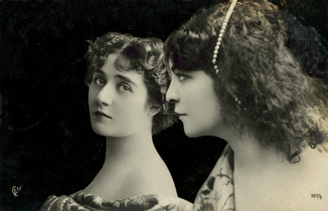 Two women pose (b/w photo)