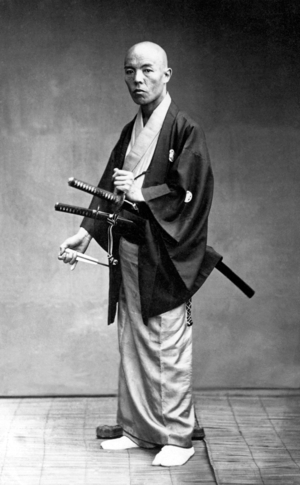 Japan: Samurai with folded fan and twin swords, c. 1870 (b/w photo)