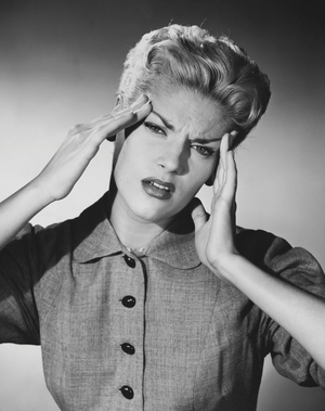 Close-up of a young woman suffering from a headache