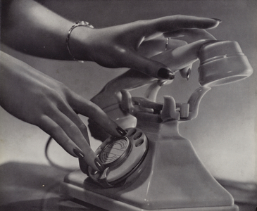 Hands of a woman about to make a telephone call (b/w photo)
