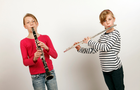 Two girls playing woodwind instruments