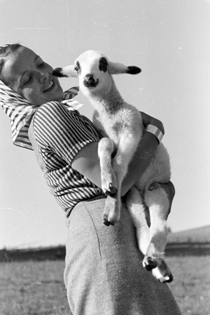 A young woman holding a spotted goat kid, St Märgen in the Southern Black Forest, Germany 1930s (b/w photo)