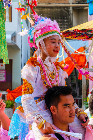 Novice monk carried on shoulders, Poy Sang Long (Shan ordination ceremony for boys aged 7-14); Wat Pa Pao, Chiang Mai, Thailand. 