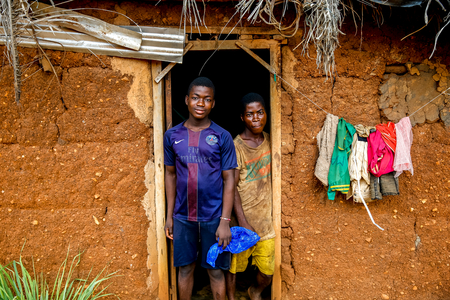 Boys outside their home in a village near Daloa, Ivory Coast (photo)