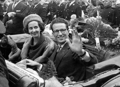King Baudouin and his ifancee Fabiola in convertible waving at the crowd, in front of the city Hall of Antwerp October, 22 1960
