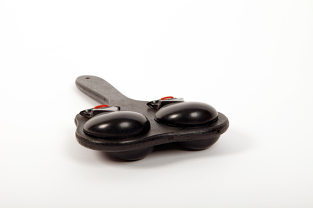 Handle, board, or paddle castanets. Two castanets mounted on either side of a board. Castanets made by Elton. Generic