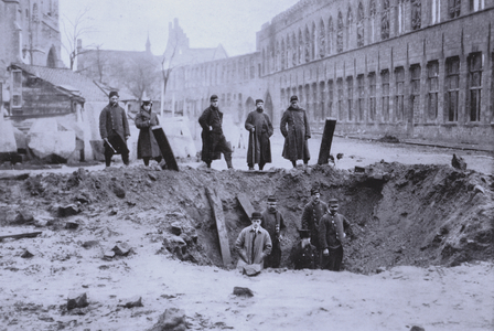 Shell hole in a street in Ypres, Belgium, World War I, 1915 (b/w photo)