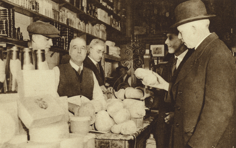 Scotsmen buying haggis from a shop in London (b/w photo)