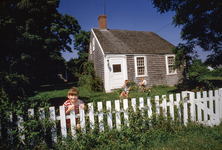 Children play in front yard of typical Cape Cod cottage. Sagamore, Massachusetts., 1960s (photo)