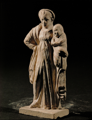 Woman holding a swaddled child on her left arm …