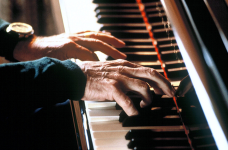 Composer and conductor Leonard Bernstein (USA) on the piano, body parts..., 1984 (photo)