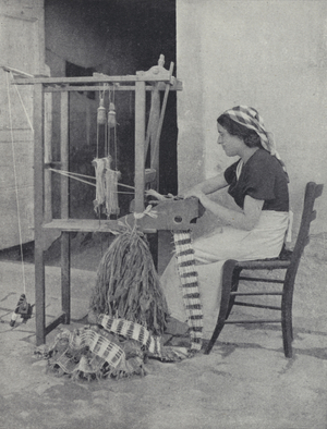 Woman making lace from straw on a simple hand loom, Fiesole, Tuscany, Italy (b/w photo)