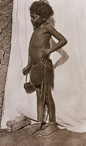 Portrait of a young girl dressed in a grass skirt, c.1906 (b/w photo) [2003/222/1/2/3]