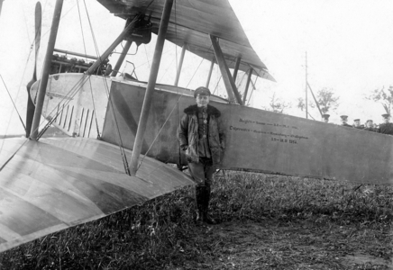 Fighter pilot next to his plane, 1914 (b/w photo)