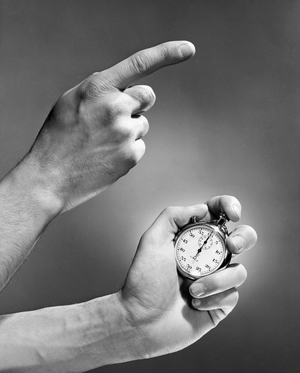 Close-up of a man's hand holding a stopwatch