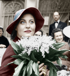 French Actress Michele Morgan Holding Bunch of Flowers Lily of The Valley on May 1St, 1952 (photo)