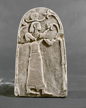 Divinity standing under an arch of flowers, with traces of red paint, from Tel Beth Mirsin, Israel (limestone)