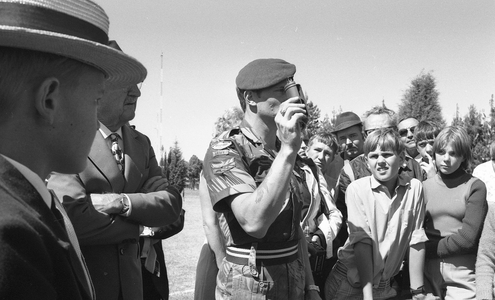 Young boys and small crowd watching a Rhodesian Light Infantry demonstration, 1976 (b/w film still)