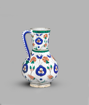 Jug decorated in cobalt blue, green and bole-red glaze, with pomegranates containing cintamani, tulips and carnations, c.1580-c.1600 (fritware (cobalt blue, red and green glaze))