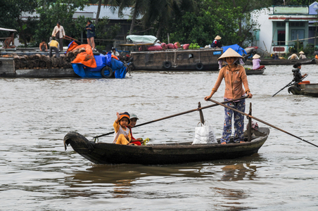 Vietnamese transport: Children crossing river in a rowing boat, Chao Doc, Mekong Delta, Vietnam