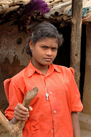 India: As this adolescent girl saw me taking pictures, she stood at a distance observing me in a village near Nagpur, Maharashtra. She gave me a non-verbal consent to take a picture before she went away. What caught my attention was the way she carried her keys around her neck. January 30, 2007.  (photo)