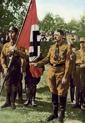 Adolf Hitler holding the Blutfahne (Blood Flag) carried at the Munich Beer Hall Putsch of 1923 (colour photo)
