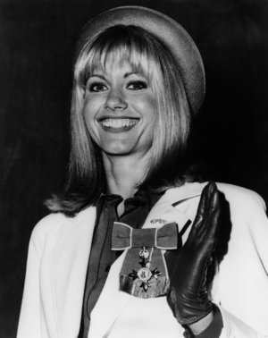 Olivia Newton-John (Newton John) With The Order of the British Empire Medal (M.B.E.). March 14, 1979 (b/w photo)