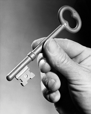 Close-up of a person's hand holding a key