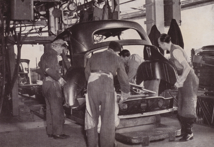 Loading car body components on to a special bogie-type assembly fixture in preparation for gun welding (b/w photo)