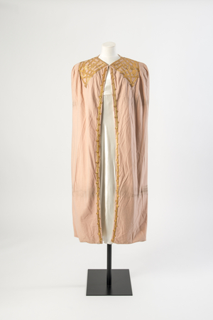 Pale pink wool cloth evening cape decorated with gold kid leather applique, c.1936 (wool cloth)