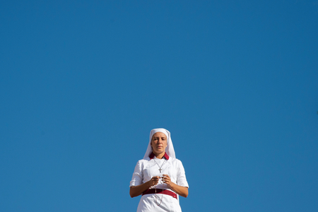 A Nun Praying the rosary before a Canonization Holy Mass in Saint Peter's square at the Vatican.