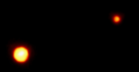 Pluto and its moon, Charon, photographed by the European Space Agency's Faint Object Camera on NASA's Hubble Space Telescope.