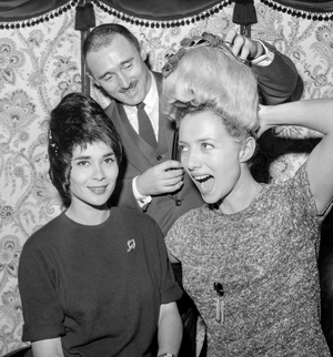 Famous haidresser Lintermans presenting the hats made with hairs, Paris, December 6, 1960 : Nicole Mariani and Stephane Audran with this new type of hat (b/w photo)