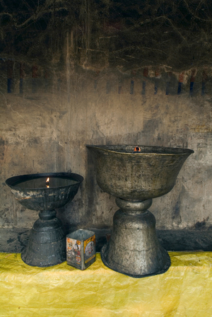 Tibetan Buddhism: Two large butterlamps burning in Thak Thok monastery (Nyingma tradition), Sakti Valley, Ladakh, India (photo)