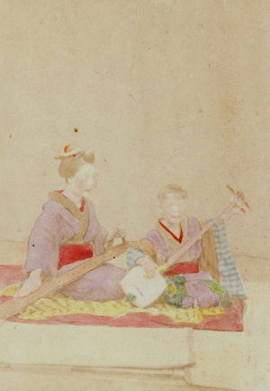 Playing "ichigenkin" (monochord) and shamisen (right), 1862-68 (photo)
